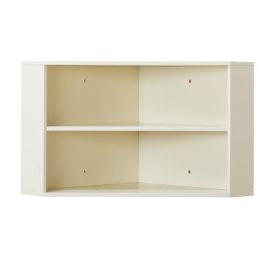 a white shelf with three shelves on each side and one door open to the other