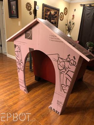 a dog house made out of cardboard on the floor