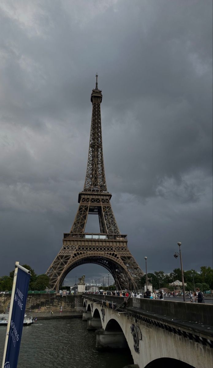 the eiffel tower towering over the city of paris, france on a cloudy day