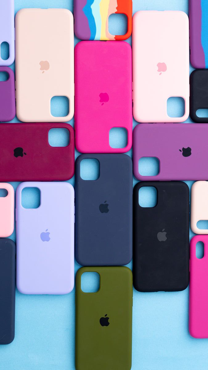 many different colored iphone cases lined up on top of each other, with one being the same color