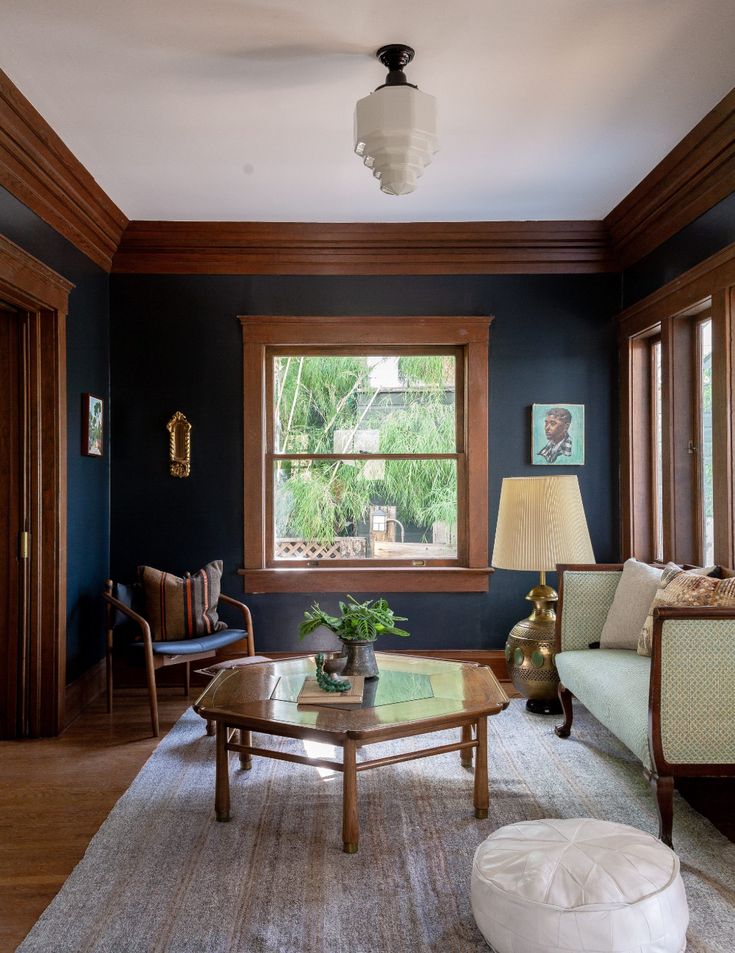 a living room with blue walls and wood trimmings, including a coffee table