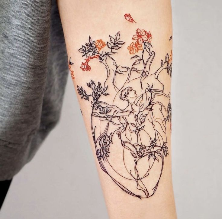 a woman's arm with flowers and leaves in a vase on her left forearm