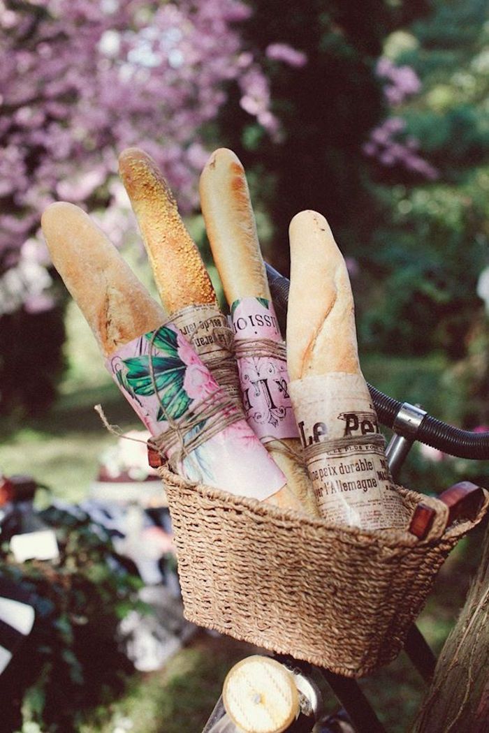 a basket filled with bread sitting on top of a bike