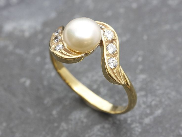 Gold Vintage Pearl Ring set with a Natural Pearl at size 8mm (AAA Grade) from Japan.Gold Vermeil: 18k Gold over Solid 925 Sterling Silver ☞ made to last. Click here for ☞ Matching EarringsMatching Pendant - please ask me Details:• Natural Pearl sourced from Japan• Pearl: 8mm, AAA Grade• Dimensions: Band width ≈ 2.5mm, thickness ≈ 1.5mm• 18K Gold Vermeil❀ Each Natural Gem is unique & will have Slight variations from the product pictures "no two Natural Stones are alike"SKU 2269 Luxury Gold Pearl Ring With Gemstone, Vintage Yellow Gold Pearl Ring For Formal Occasions, Antique Yellow Gold Pearl Ring, Luxury Vintage Gold Pearl Ring, Luxury Antique Gold Pearl Ring, Gold Antique Ring, Vintage Pearl Ring, Pearl Ring Design, Natural Pearl Ring