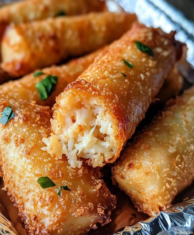 some fried food is on a plate with parmesan cheese and seasoning sprinkles