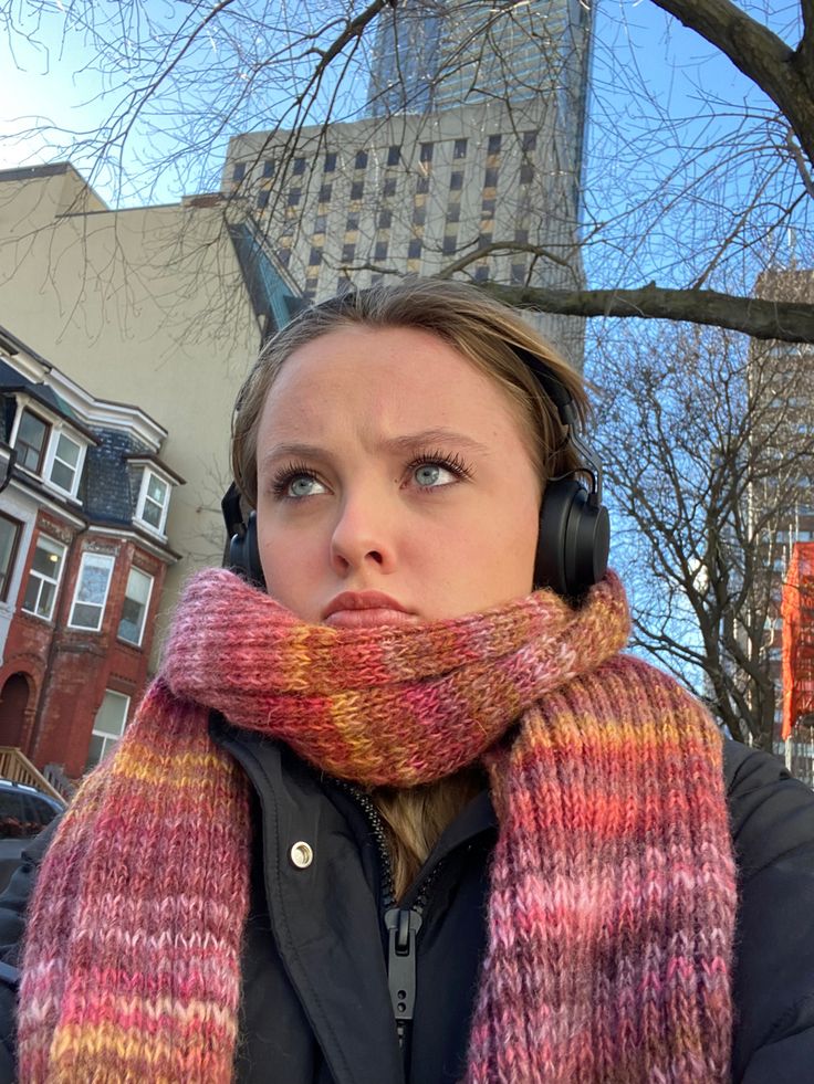 a woman wearing headphones and a scarf