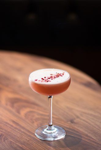 a drink sitting on top of a wooden table