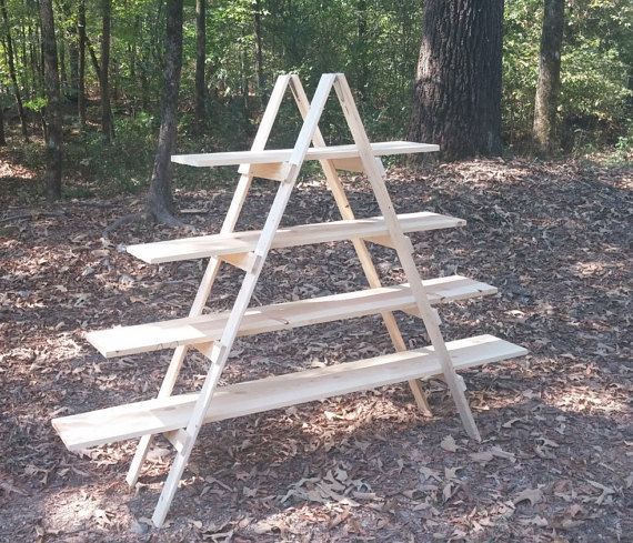 three wooden shelves stacked on top of each other in the woods