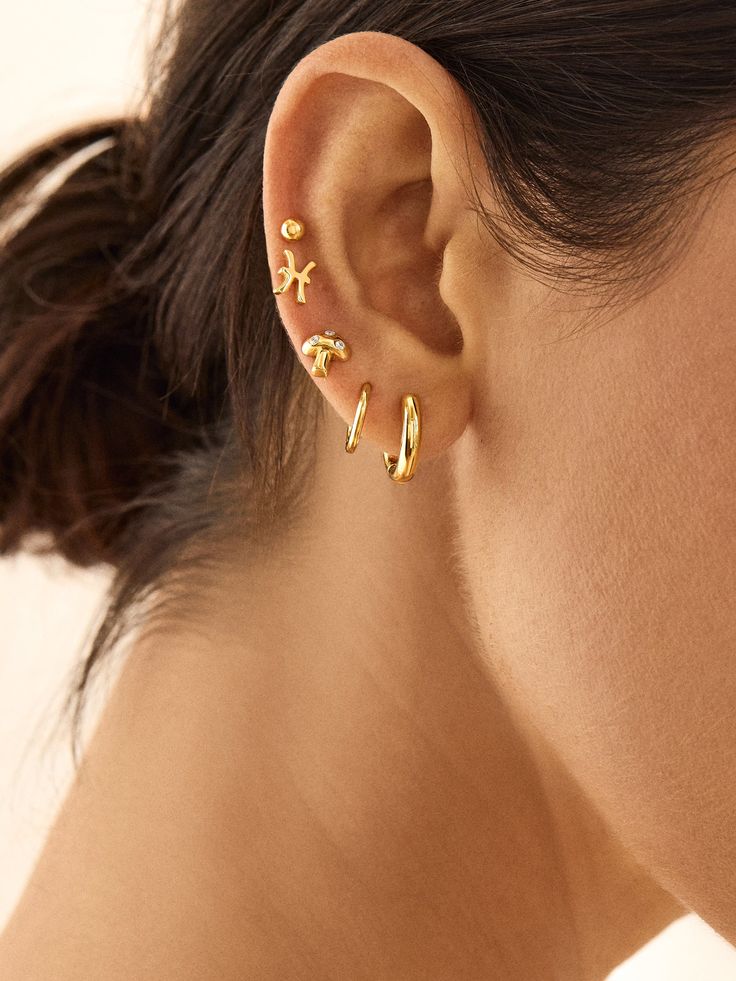 Add a whimsical flair to your look with the 18K Gold Just For Fun Earrings. Its fungi design brings the fun, but they’re delicate and dainty enough to pair well with other everyday styles. Available in classic gold or with shimmering cubic zirconia stones, these studs are made to last with their 18k gold plated sterling silver construction. Gold Earrings With Mushroom Design For Gift, Gift Gold Earrings With Mushroom Design, Gold Mushroom Design Drop Earrings, Zodiac Piercing Ear, Piercing Layout, Earring Stacks, Zodiac Earrings, Small Ears, Earring Stack