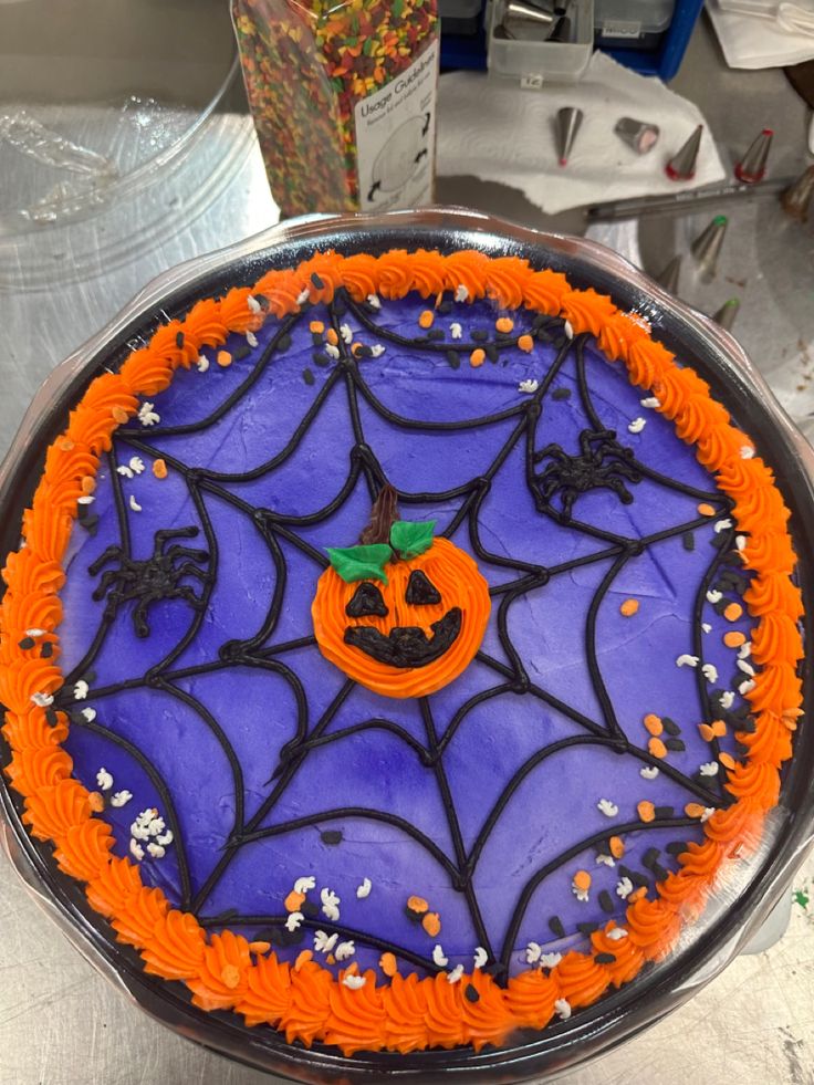 a halloween cake with orange and purple frosting