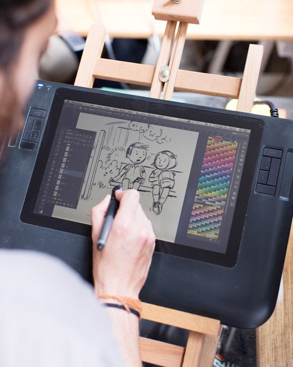 a person is drawing on an ipad