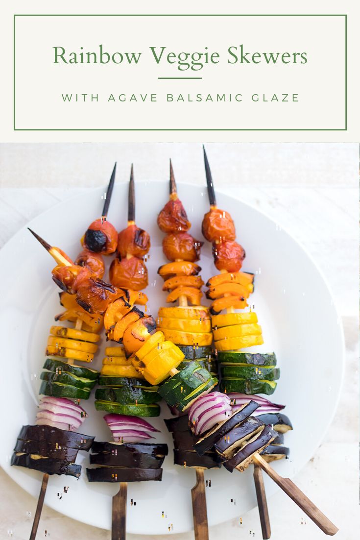 rainbow veggie skewers with acave balsamic glaze on a white plate