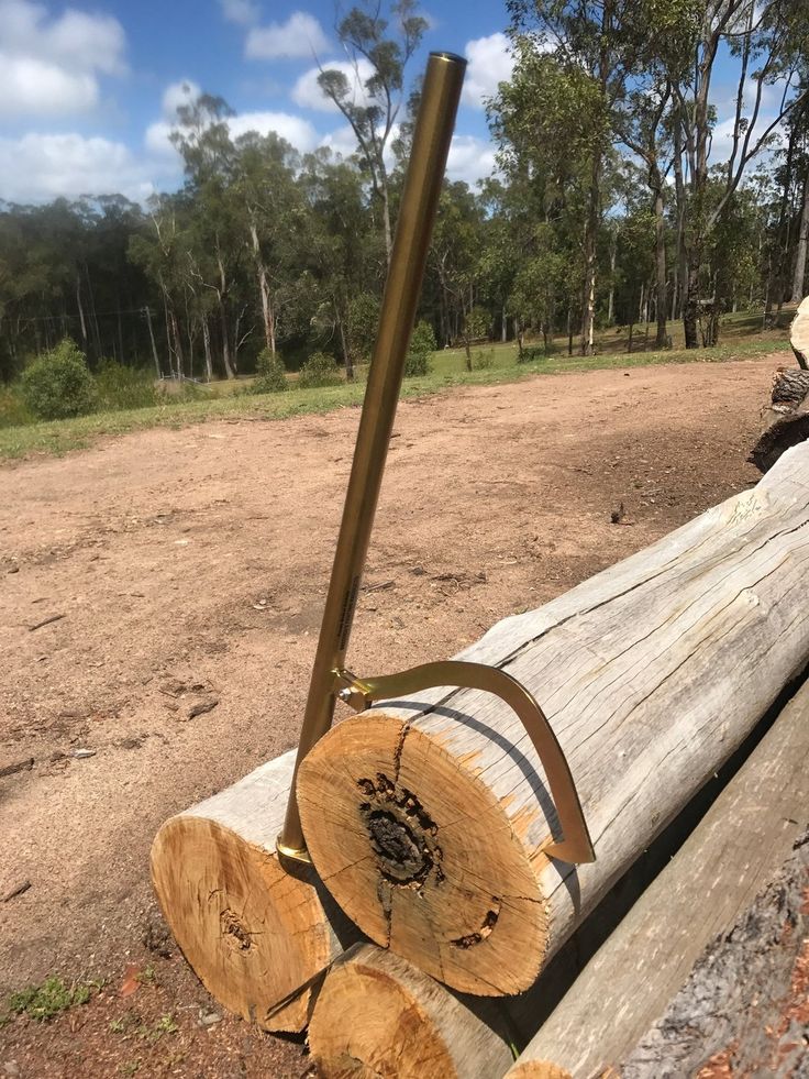 a pile of logs sitting on top of a dirt field