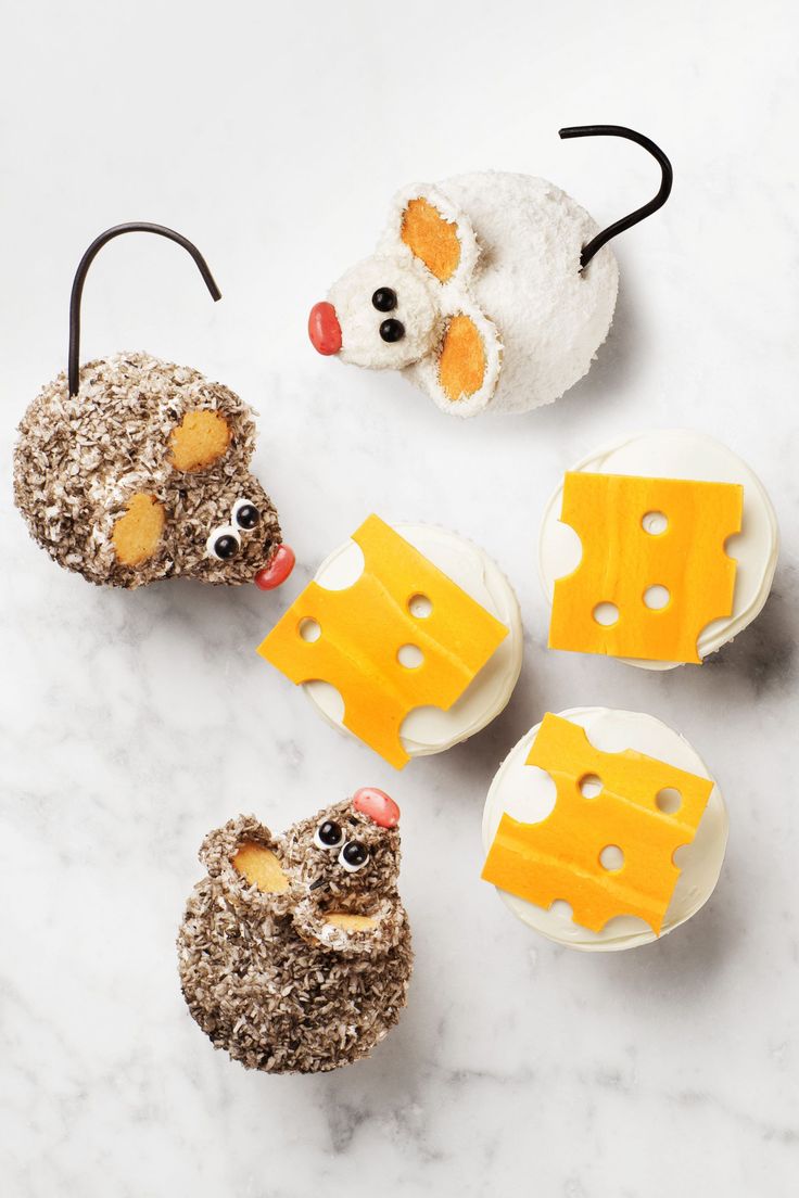 some food that is shaped like animals with cheese on them