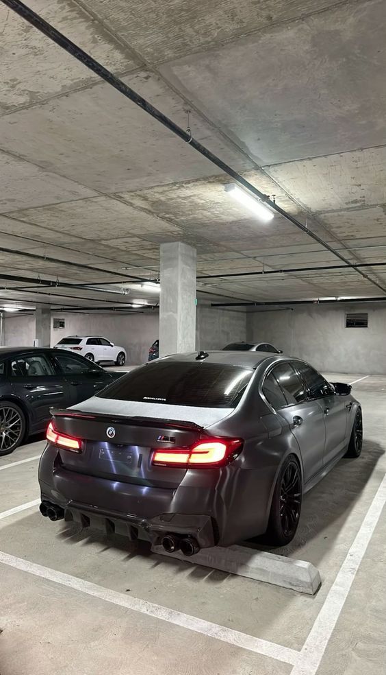 two cars parked in a parking garage next to each other