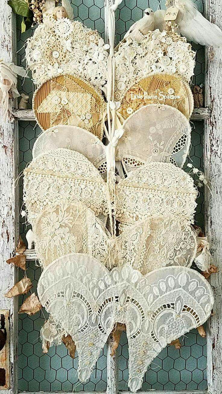 an old window with lace and flowers on it