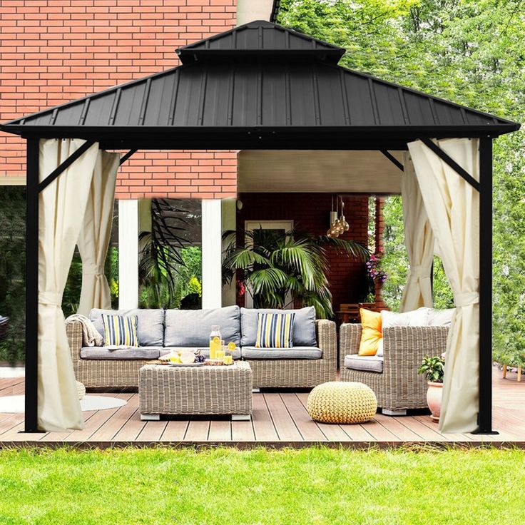 a black and white gazebo sitting on top of a wooden deck