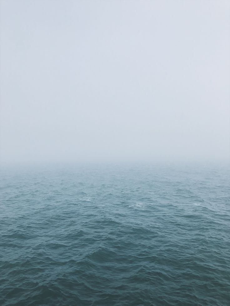 the ocean is covered in fog and water