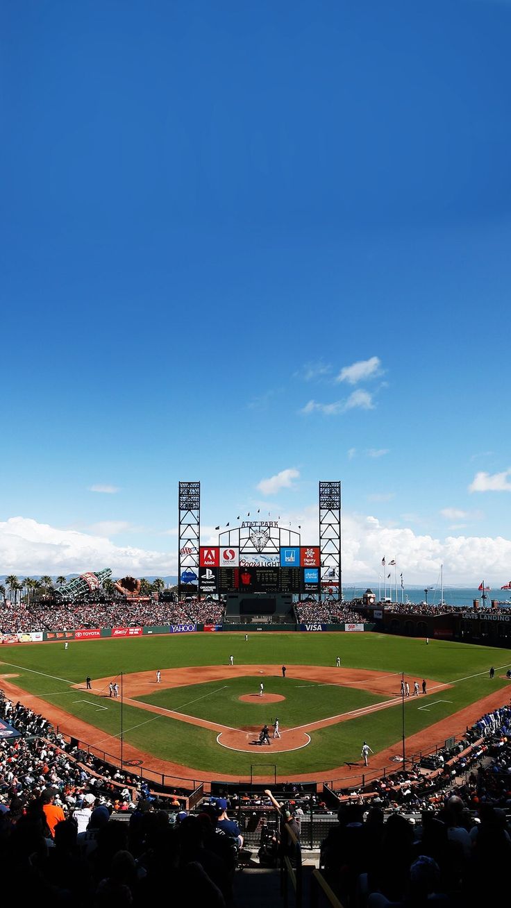 a baseball game is being played on a sunny day at a stadium with the sky in the background