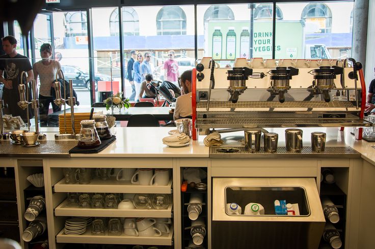 a coffee shop with lots of cups on the counter