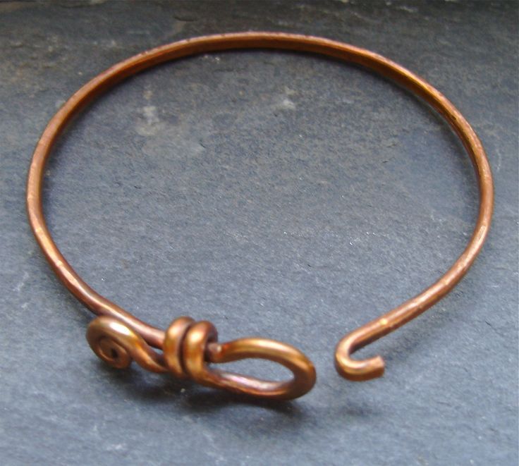 a close up of a metal object on a table with a black surface in the background