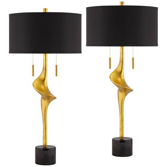 two lamps with black shades on them