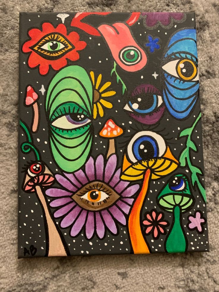 a painting on the ground with an eye and flowers