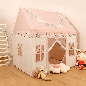 there is a pink tent with white trim on the roof and two teddy bears in front