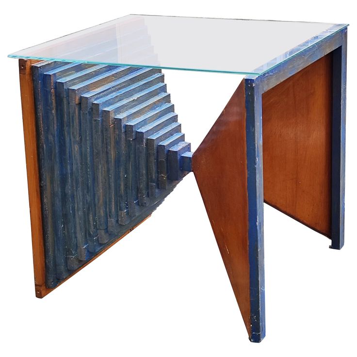 a glass and metal table with an abstract design