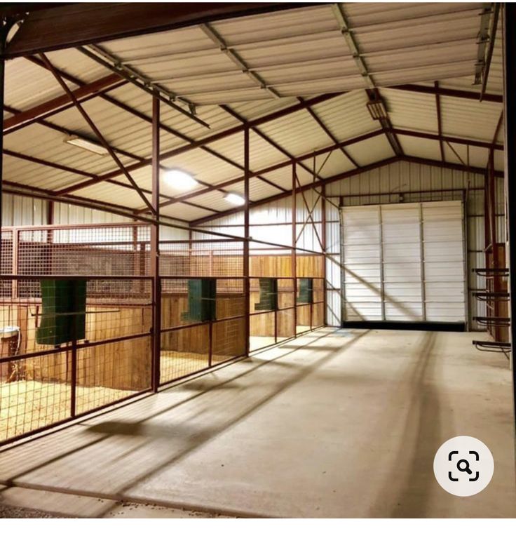 the inside of a building with lots of wood and metal fencing on it's sides