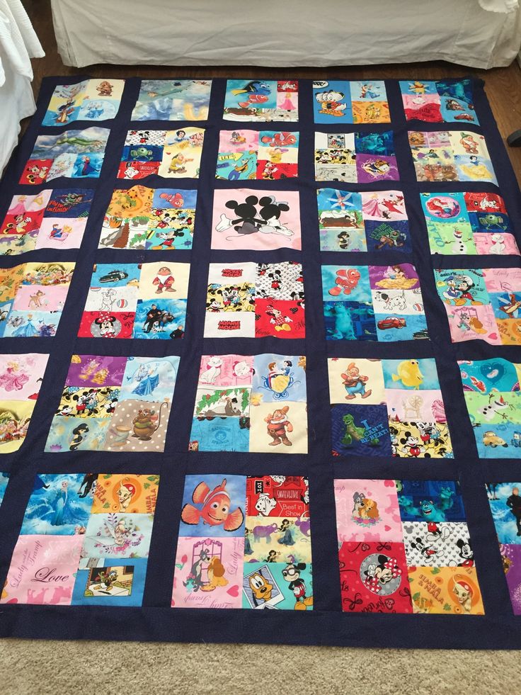 a mickey mouse themed quilt on the floor