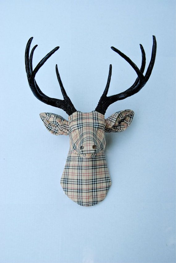 the head of a deer with large antlers on it's face is made out of plaid fabric