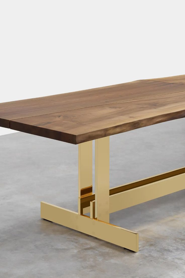 a wooden table with metal legs on concrete floor