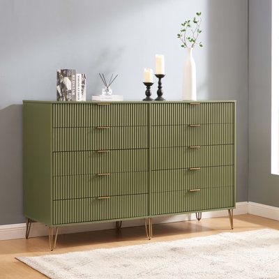 a green dresser with candles and vases on top