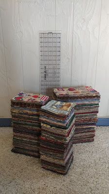 a stack of multicolored papers sitting next to a white wall with a metal grate in the background