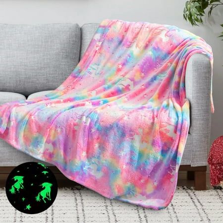 a couch with a blanket on top of it next to a green glow in the dark logo