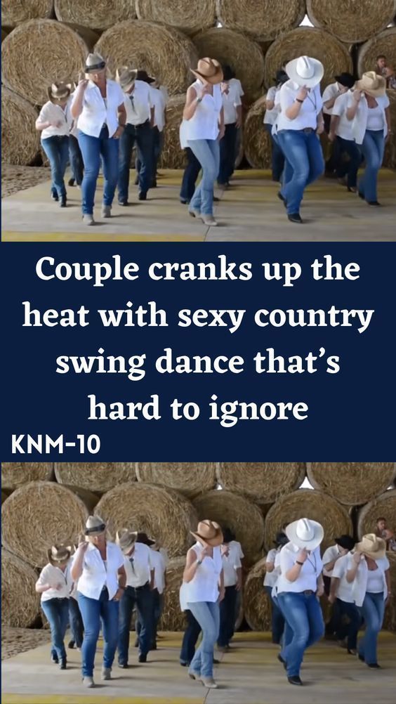 some people are dancing in front of hay bales and one is wearing a cowboy hat