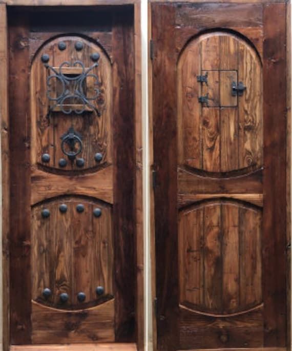 two wooden doors with metal hardware on them