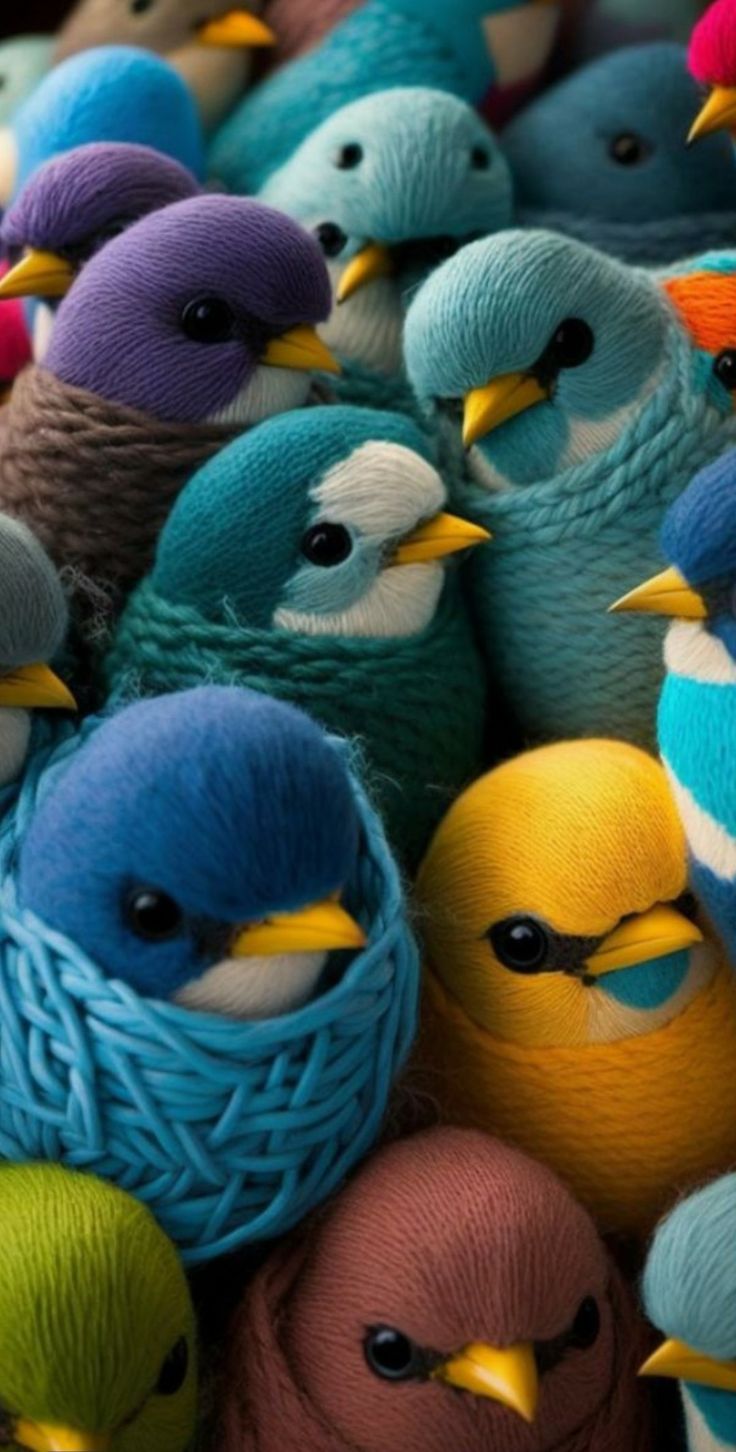 many different colored birds sitting together on top of each other's heads and beaks