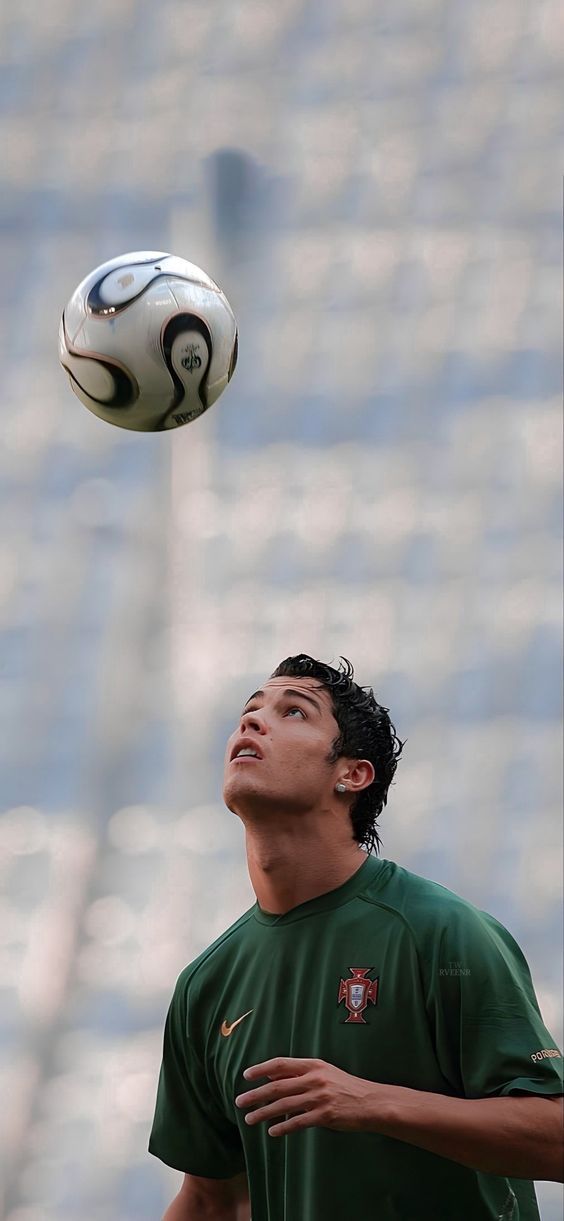 a young man is playing with a soccer ball