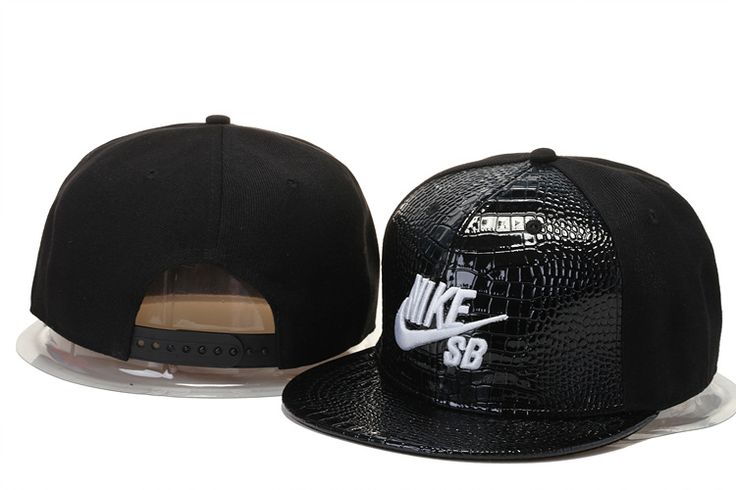 a black hat with white nike logo on the front and side, next to a plastic container