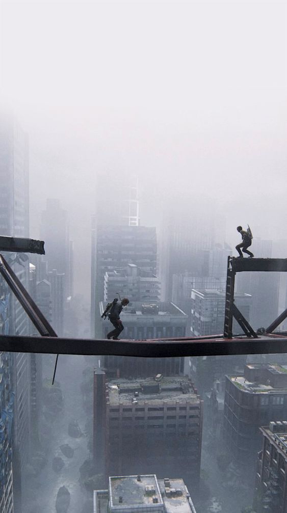 two people walking across a bridge in the middle of a city on a foggy day