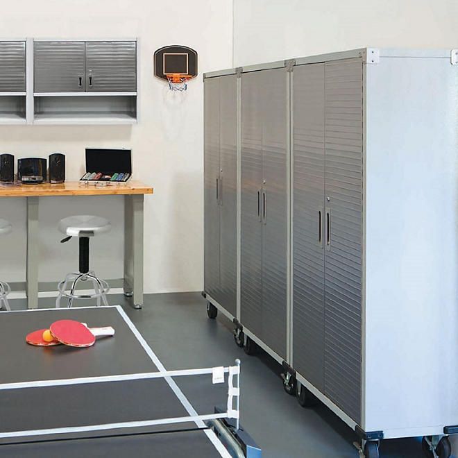 a ping pong table in the middle of a room with lockers and chairs