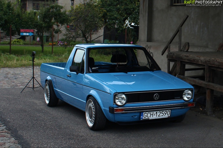 a blue pick up truck parked in front of a building