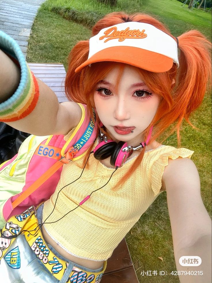 a girl with orange hair wearing headphones