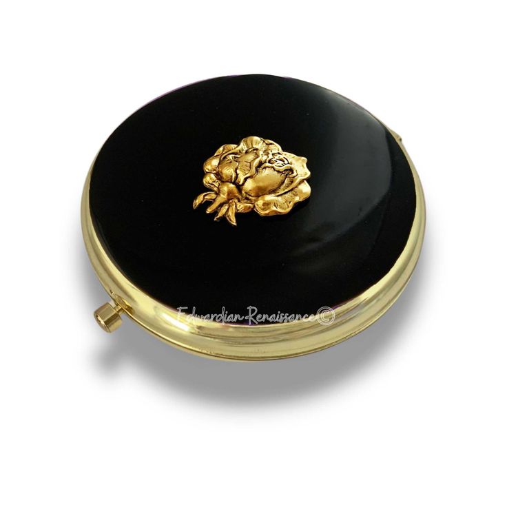 a black and gold round box with a golden lion on the front, sitting on a white surface