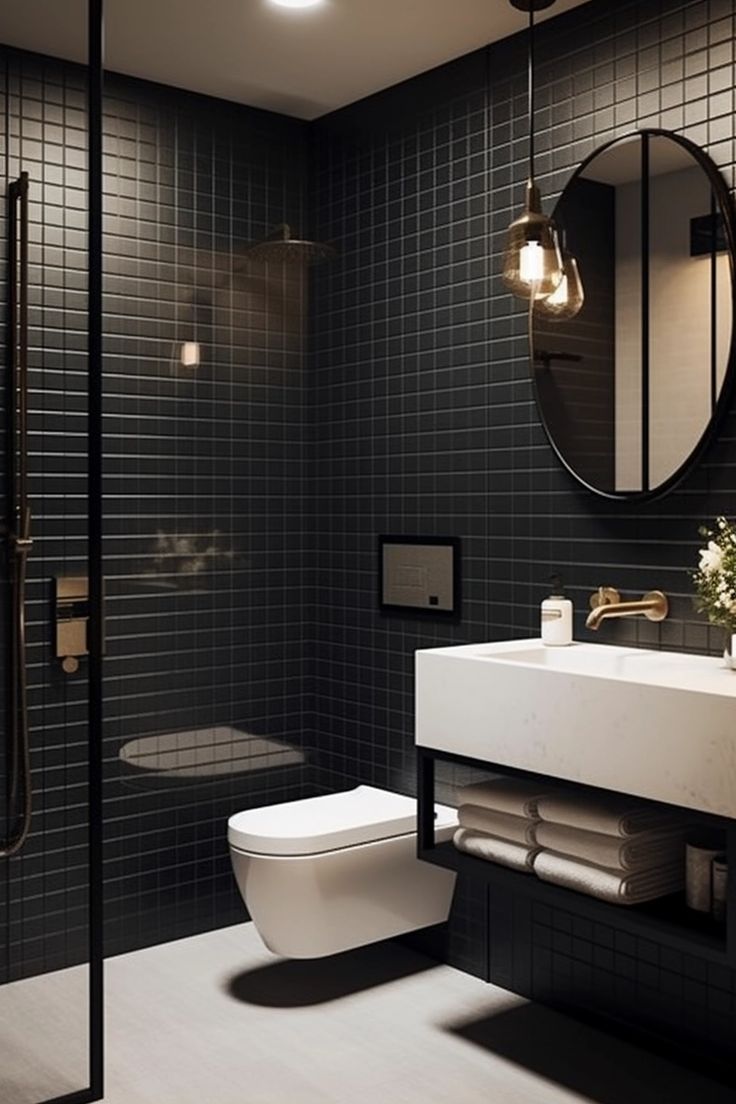 a bathroom with a toilet, sink and shower in black tile wallpapered walls