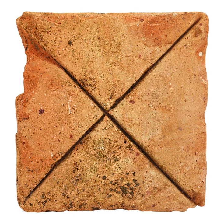 a square stone with two intersecting lines on it