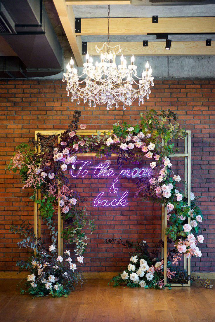 the wedding arch is decorated with flowers and greenery for an elegant touch to the space