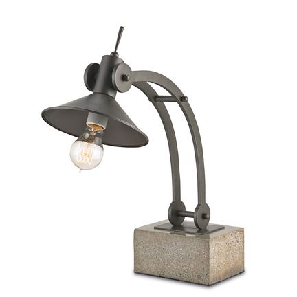 a lamp that is sitting on top of a cement block with a light bulb attached to it